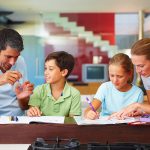 Children-being-helped-by-their-parents-with-homework